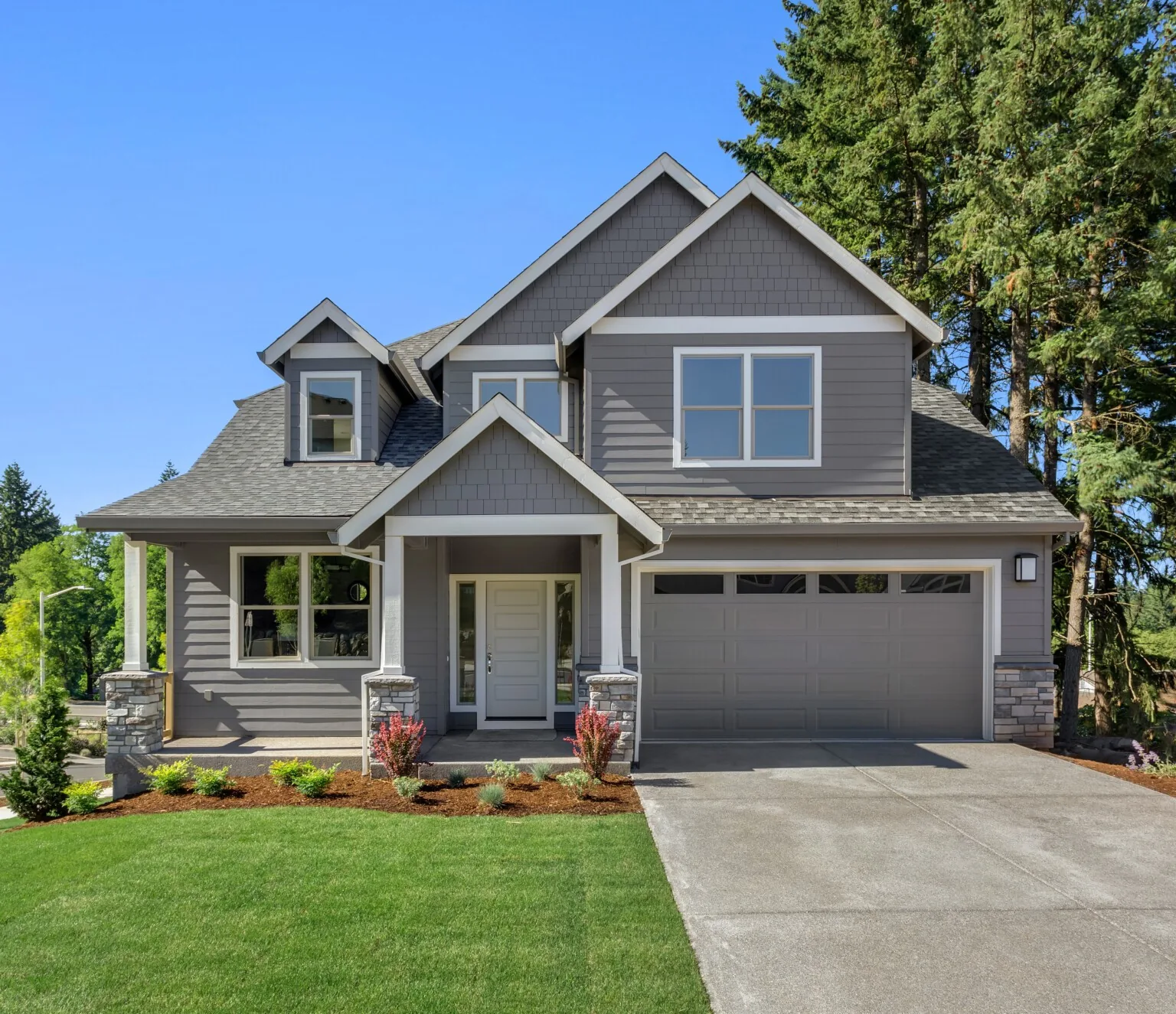 Gray New England home with a clearly visible shingle roof